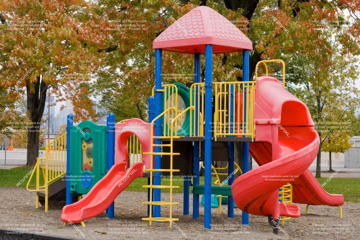 A vibrant outdoor playground featuring colorful slides and climbing structures, surrounded by open space ideal for families and pets to enjoy. The area is lively, hinting at an inviting community atmosphere, with visible green space and ample room for walking or play.