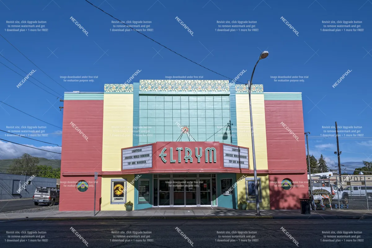 This image features the ELTRYM marquee sign with its colorful facade and striking art deco architectural details. The scene exudes a sense of nostalgia and liveliness, inviting viewers to experience community gatherings and cultural events in downtown Baker City.